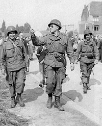 Three soldiers of the 506th leaving the area and going to the assigned meeting place.