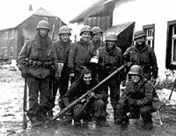 William Bramswig is the one holding the bottle the picture was taken in a deserted town in Germany 1945.