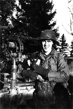 Dan in Belgium in December 1944 holding a dog.