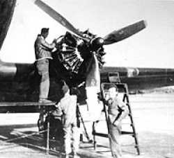 Inspecting the engines in Orleans France 1944 Charles is next to the ladder.