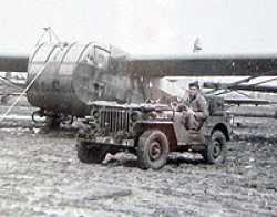 A soldier from Mahlon Sebring's outfit watching over the parked CG4A Gliders