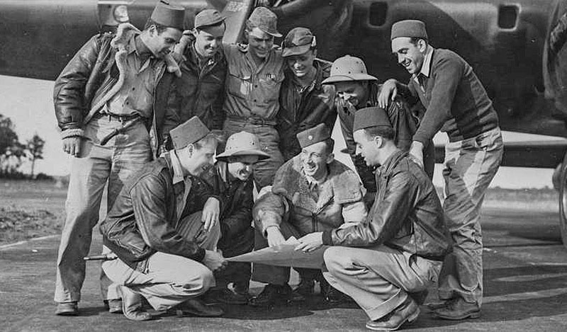 Members of the 100th Bomb Group at RAF Thorpe Abbotts on August 17, 1943. Frank D. Murphy, is kneeling on the left with a dagger in his pocket.