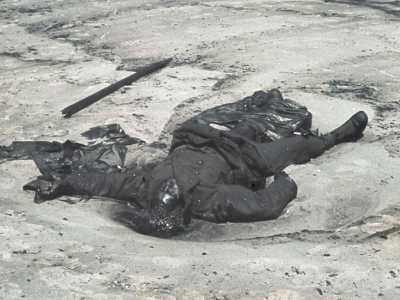 Oil-covered body of a British soldier