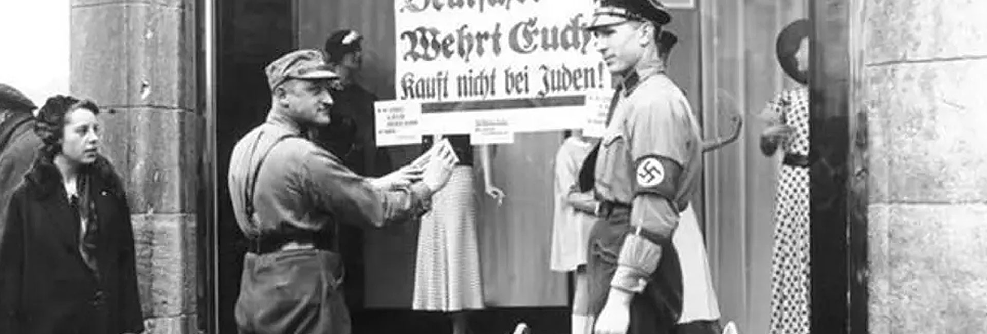 SA members enforce the nationwide boycott of Jewish businesses in Germany on 1 April 1933, marking one of the first organised acts of Nazi persecution.